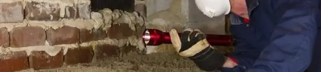 Pest control technician inspecting a crawl space for ant activity and entry points in Allentown, PA
